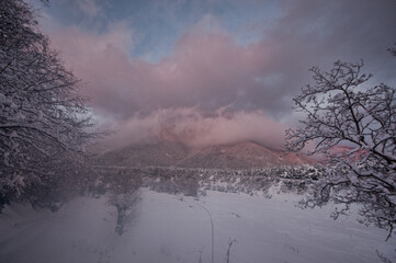 Majestic sunset in the winter mountains landscape. Dramatic sky. Azerbaijan nature.