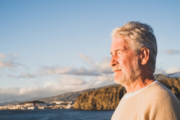 Fototapeta premium close up and portrait of sad and pensive man looking at the sea in the beach - upset people lifestyle concept
