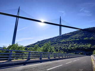 A summer panorama of a great white cable bridge. Bridge crossing the valley.  Natural panoramic view. Highest bridge. Bridge over the river