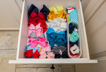 Girls bows, scrunchies, and headbands organized in a drawer