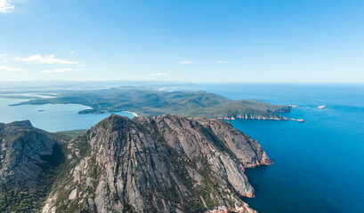 Beautiful high angle panoramic aerial drone view of Coles Bay and Freycinet National park with Richardsons Beach left and Cape Tourville on the right. Famous Hazards mountain range in the foreground.
