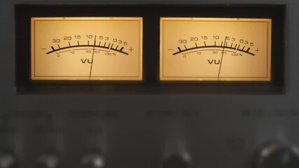 Audio signal levels monitoring audio console on classic sound amplifier. Close-up analog signal indicator with arrow