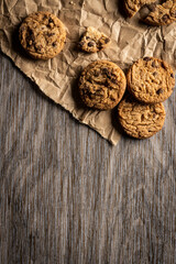 freshly baked Chocolate chip cookies on a wooden table with place for text. Copy space.
