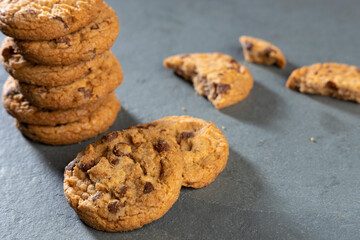 freshly baked Chocolate chip cookies on a dark stone with place for text. Copy space.