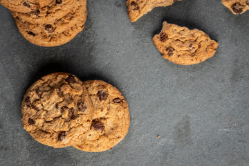 freshly baked Chocolate chip cookies on a dark stone with place for text. Copy space.