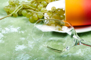Green grapes with an empty wine glass around