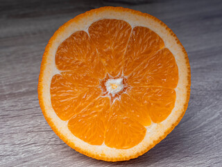 Orange slices on a wooden gray table
