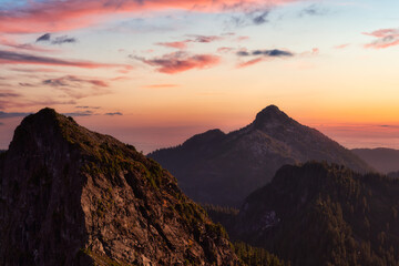 Beautiful aerial landscape view of Mountain Peaks near Vancouver, British Columbia, Canada. Colorful Cloudy Sunset Sky Art Render.