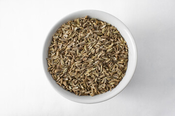 Top view of fennel seeds in bowl isolated on white background