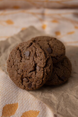 Stack of chocolate chip cookies on rustic paper