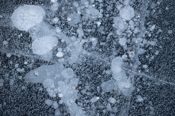 Bubbles and Cracks Details in the Ice. Lots of interesting lines and air bubbles trapped in the ice. Abstract background texture.