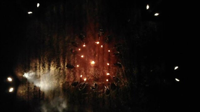Men in black with torches, procession, rite