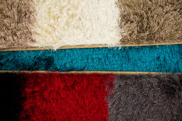 Group of three colorful carpets stacked
