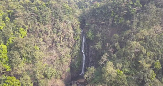 Forested Mountains With Cascading Mainapi Waterfall At Netravali Taluka Of South Goa, India. - Aerial Drone Shot
