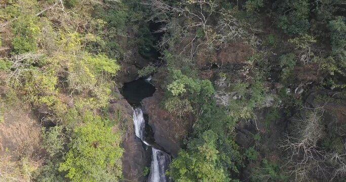Scenic Cascade Of Mainapi Waterfall In Canacona, South Goa, India. aerial drone