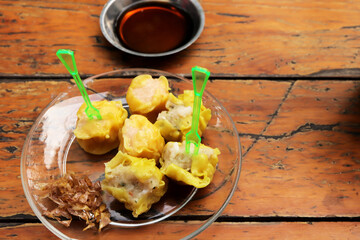 Shrimp Chinese Steamed Dumpling with garlic on the wood table.