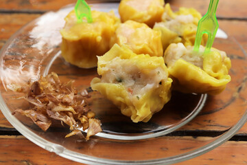 Shrimp Chinese Steamed Dumpling with garlic on the wood table.