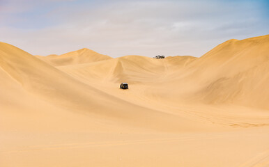 Fototapeta na wymiar Offroad Vehicle In The Desert At Sandwich Harbor Walvis Bay Namibia