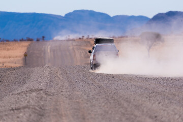 Car On A Gravel Track In Namibia