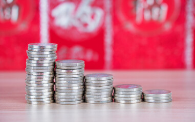 Decreasing euro coins in front of red envelope