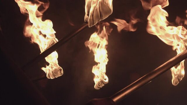 - men in black with torches, procession, rite