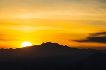 Sunrise over the volcanoes in a cloudy day