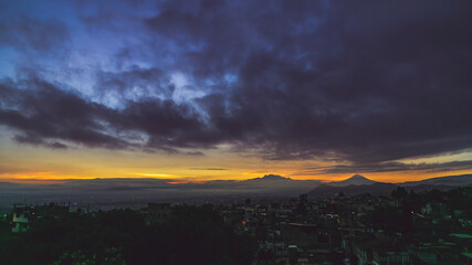 Sunrise over the volcanoes in a cloudy day