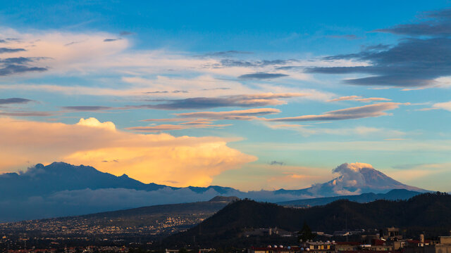 Sunrise over the volcanoes in a cloudy day