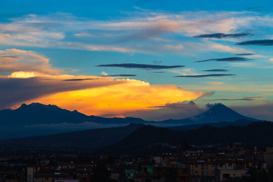 Sunrise over the volcanoes in a cloudy day