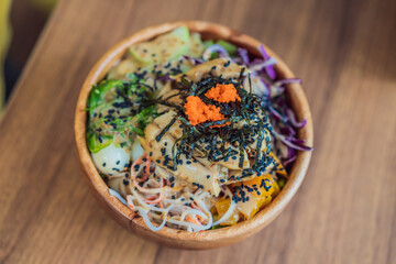 Raw Organic Poke Bowl with Rice and Veggies close-up on the table. Top view from above horizontal