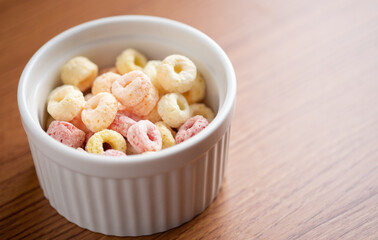 Cereal flakes in bowl ceramic with copy space,Breakfast concept.Food with delicious fruity taste and fruity colours.It's made with maize,wheat,and barley.