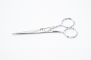 Silver scissors on white background.Paper cutting tool.Items for cutting hair on white background.