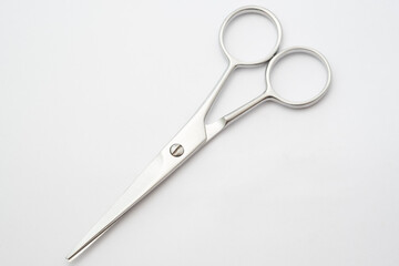 Silver scissors on white background.Paper cutting tool.Items for cutting hair on white background.