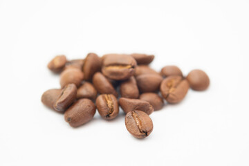 Bean coffee in isolated white background. Medium roasted coffee beans are light brown in color in white background.