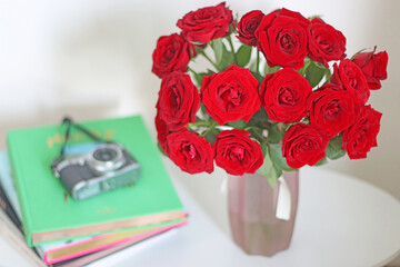 Blooming red roses in vase