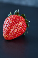 Fresh red strawberry on dark background. Close up