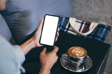 cell phone blank white screen mockup.woman hand holding texting using mobile on desk at office.background empty space for advertise.work people contact marketing business,technology