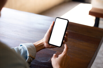 cell phone blank white screen mockup.woman hand holding texting using mobile on desk at office.background empty space for advertise.work people contact marketing business,technology