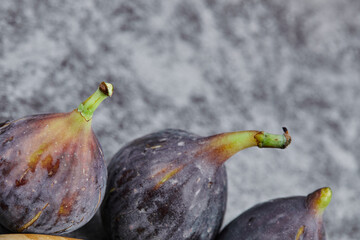 Purple ripe figs on a marble background