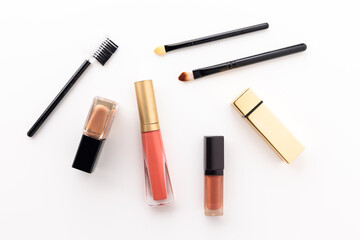 Obraz premium Plenty of makeup on the white table with eyelash brush, eye shadow, lipstick.
