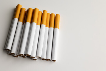 Many cigarettes stacked together. Drugs are harmful to the respiratory system.