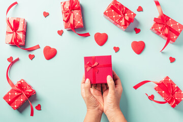 Woman hands holding gift or present box decorated and red heart surprise