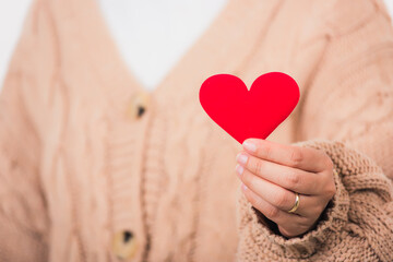 Female beauty hands holding modern a red heart