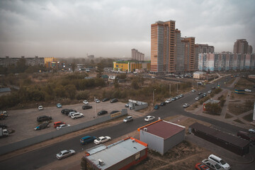 Fototapeta premium City view with modern architecture and a frightening gloomy thunderstorm sky with dark clouds