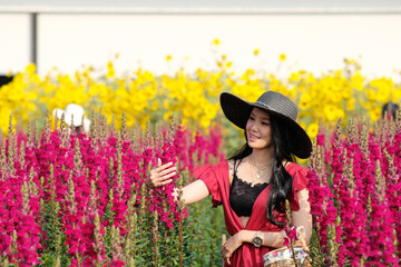 Portrait of happy asian woman in the cockscomb flower garden and relaxing on holiday
