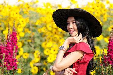 Portrait of happy asian woman in the cockscomb flower garden and relaxing on holiday