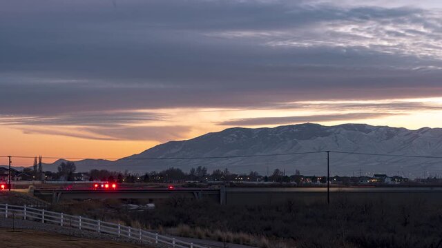 Sunset to dark night with a highway and emergency response crew, mountains and lots of airplane light trails - long exposure time lapse
