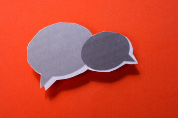 Mini speech bubbles cut out of paper in view