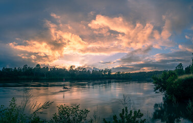 Moody Panoramic Riverside Sunrise with Cloud Reflections