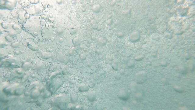 Air bubbles forming under ocean with man drowning while practicing adventure sports underwater in Phi Phi Island, Phuket, Thailand